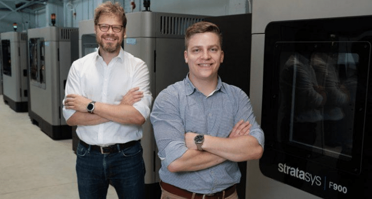 AM Craft Co-founders Jānis Jātnieks (right) and Didzis Dejus in front of the service provider’s four large-scale production-grade Stratasys F900 3D Printers